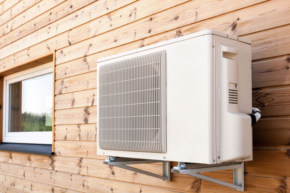 Exterior Air Conditioning Unit on a Wooden Wall Side View — Air Conditioning Professionals in Taree, NSW