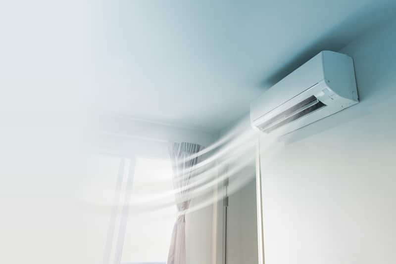 Air Conditioner on Wall with Curtain — Air Conditioning Professionals in Pacific Palms, NSW